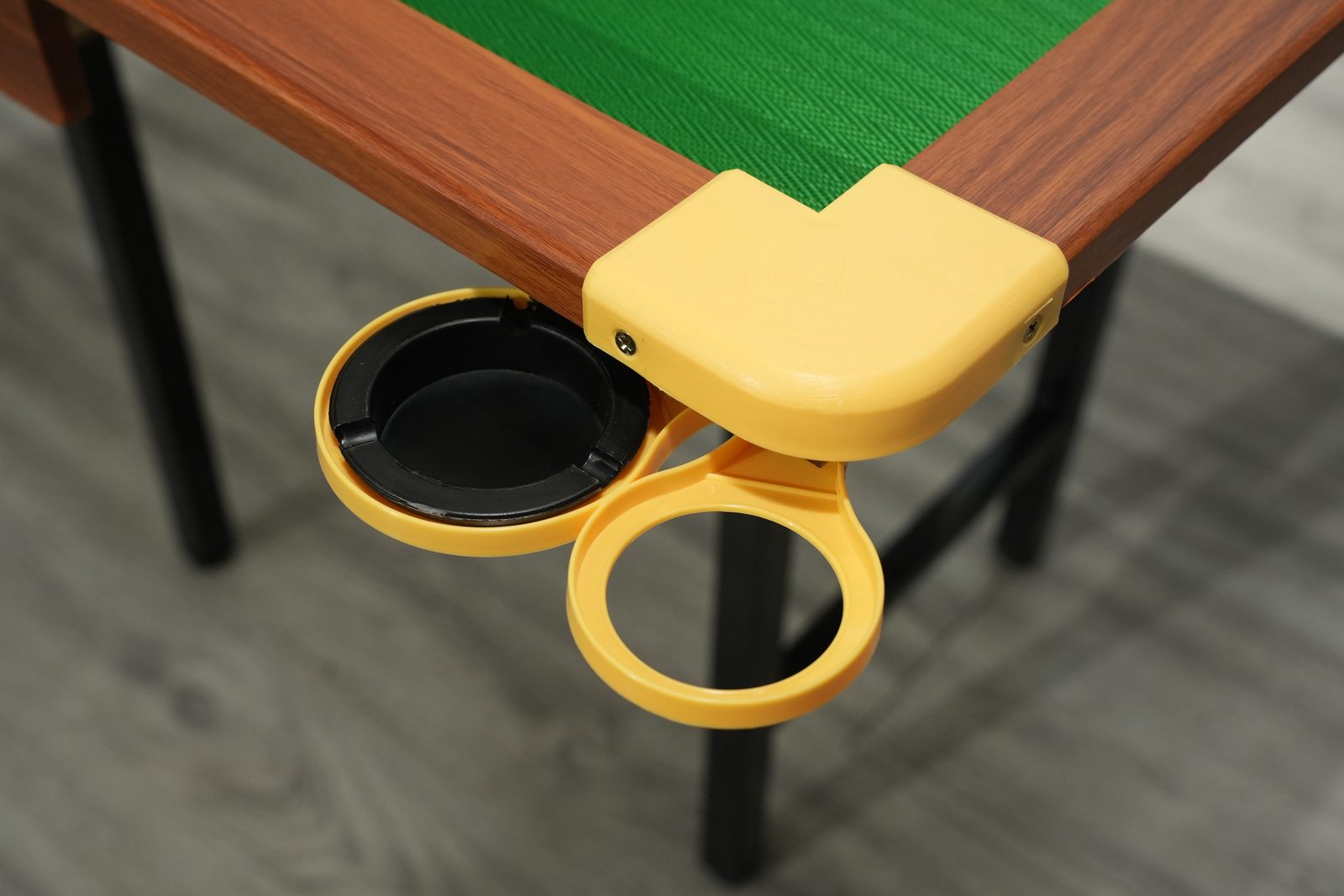 Cup holder and ashtray attached to table corner